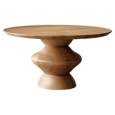 a round wooden table sitting on top of a white floor