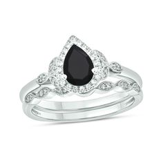 Win her heart with the vintage and nature-inspired details of this pear-shaped black sapphire and diamond frame bridal set in white gold. Fashioned in cool 10K white gold The engagement ring showcases a 7.0 x 5.0mm pear-shaped rich black sapphire glistening in a diamond-lined frame. Leaf-like marquise shapes flank the centerpiece with diamonds. Seal your vows with the coordinating wedding band, shimmering with a row of diamond duos in marquise-shaped frames. Intricate milgrain borders add heirlo Framed Leaves, Gold Book, Diamond Frame, Black Diamond Ring Engagement, Black Sapphire, Diamond Bridal Sets, Marquise Diamond, Gemstone Engagement Rings, Bridal Set