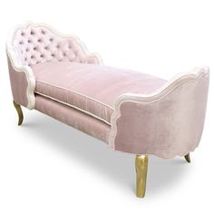 a pink velvet chaise lounge with gold legs