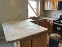 a kitchen with an island and stove top oven