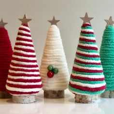 small crocheted christmas trees are lined up