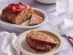 two plates with slices of meatloaf on them