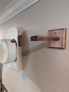 a toilet paper dispenser mounted to the wall next to a roll of toilet paper