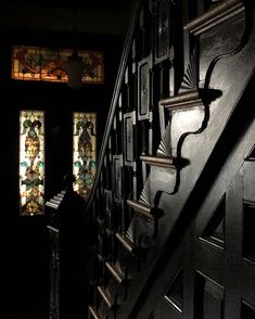 an image of stairs with stained glass windows in the background