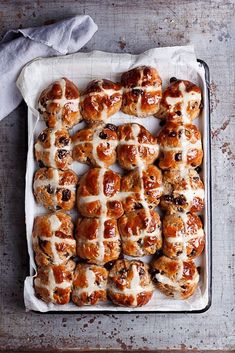 hot cross buns in a baking pan with icing