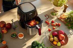 an image of a juicer filled with fresh fruits and vegetables on a kitchen counter