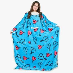 a woman wrapped in a blue blanket with hearts on it