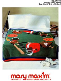 there is a bed with a baseball blanket on it