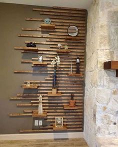 there is a wall made out of wooden pallets with shelves on each side and vases in the middle