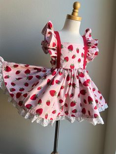 Handmade STRAWBERRY DRESS. Made with good quality strawberry cotton fabric. Lined cotton bodice and eyelet trim skirt. Elastic waist and tie back shoulder bow 6-12 mos 18" waist 17" length  12-18 mos 19" waist 18" length  18-24/2T 20" waist 20" length  3T 21" waist 21" length  4T 22" waist 22" length  5y 23.5"waist  23" length  6y 24.5" waist  24" length  7/8y 26" waist 26" length  9/10y 28" waist 28" length  12y 29.5" waist 29" length Playful Strawberry Print Dress For Beach, Strawberry Dress For Kids, Cheap Strawberry Print Sleeveless Dress, Baby Strawberry Dress, Strawberry Shortcake Dress, Strawberry Shortcake Kids Clothes, Strawberry Dress, Tie Backs, Toddler Dress