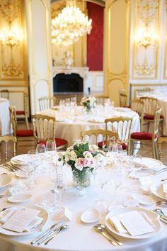 the table is set with white plates and silverware