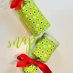 three wrapped presents with red bows on top of each other and the words sale written in green