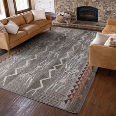 a living room filled with furniture and a fire place next to a stone brick fireplace