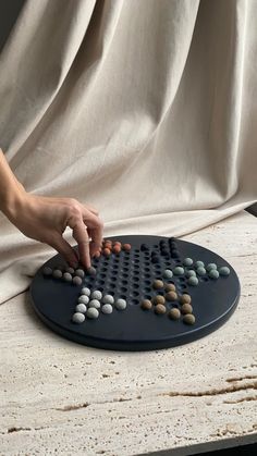 a person placing rocks on top of a board game