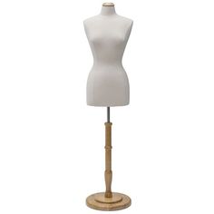 a white mannequin on a wooden stand