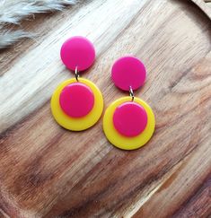 Introducing these fabulous retro drop earrings! Inspired by Pop Art designs from the 1960s, these colour block earrings are sure to make a statement. Handmade in bright pink and yellow resin, these colourful earrings are crafted to create a sleek and modern look. The geometric design adds a touch of sophistication, while the bold design adds a pop of contrast. Perfect for any occasion, these unique earrings are a must-have accessory for those who love to embrace retro vibes with a modern twist. Retro Multicolor Drop Earrings, Retro Dangle Jewelry, Handmade Retro Multicolor Earrings, Retro Handmade Drop Earrings, Retro Yellow Earrings For Party, Retro Multicolor Jewelry With Matching Earrings, Yellow Retro Party Earrings, Retro Yellow Party Earrings, Retro Multicolor Earrings For Parties