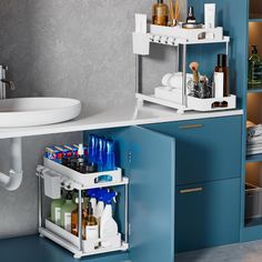 a bathroom with blue cabinets and white counter tops, two shelves holding various toiletries