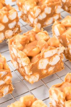 several pieces of dessert sitting on a cooling rack with peanut butter and marshmallows