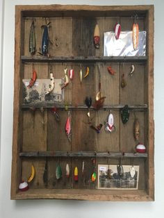 an old wooden shelf with fishing lures on it