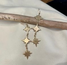 "These Falling Stars earrings feature our original hand formed bronze star component. A beautiful cascade of three falling stars makes an ethereal statement in a light-weight earring. Ear wires are 14k gold filled and the length is approximately 2.5\"." Stars Earrings, Falling Star, Beads Craft Jewelry, Falling Stars, Franklin Tn, Bronze Jewelry, Jewelry Lookbook, Jewelry Inspo, Light Weight Earrings