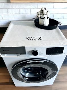 a washing machine sitting on top of a wooden floor