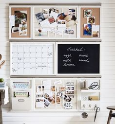 a white wall with pictures and magnets attached to the wall next to a desk