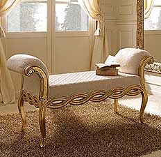 a bedroom with a large mirror and a bench in front of the window that has curtains on it