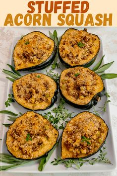 four stuffed eggplant halves on a white plate with green garnishes