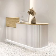 a white and wooden reception desk in an office