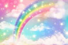 a rainbow in the sky with clouds and stars