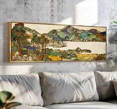 a painting hanging on the wall above a couch in a room with a potted plant