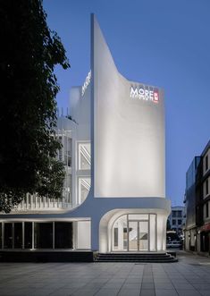 a large white building sitting on the side of a street