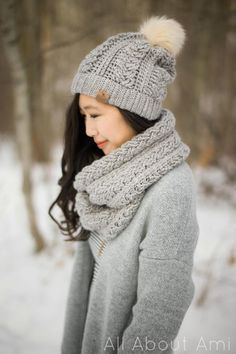 a woman wearing a hat and scarf in the snow