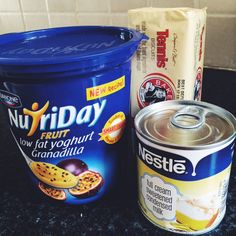 some food is sitting on the counter next to a can of ice cream and a bag of cookies