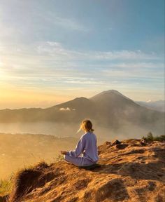 a person sitting on top of a hill