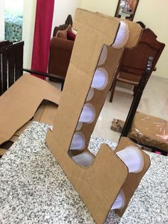 an open cardboard letter sitting on top of a counter next to a chair and table