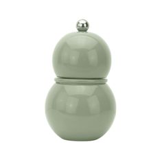 a green ceramic container with a lid on the top and an object in the middle