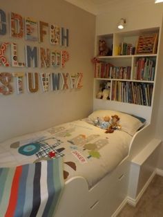 a child's room with a bed, bookshelf and bookcases