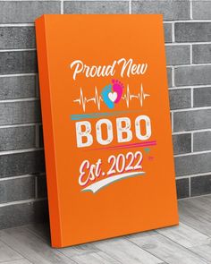 an orange sign that says proud new bobo est 2020 on it next to a brick wall