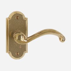 an antique brass door handle on a white background