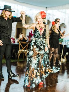 a man and woman dancing on a dance floor in front of other people at a party