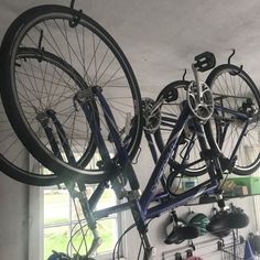 there are two bikes hanging from the ceiling