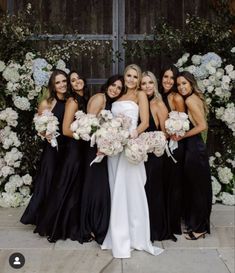 a group of women standing next to each other holding bouquets