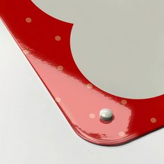 a close up of a red and white object with polka dots on the bottom half