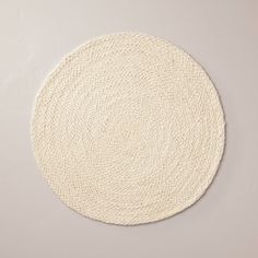 a white round rug is on the floor