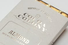 a close up of a white box with gold trimmings on the front and side