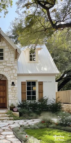 a white house with brown shutters and a stone path leading to the front door