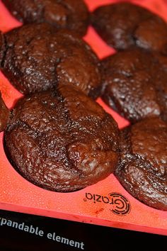 chocolate cookies sitting on top of an orange tray