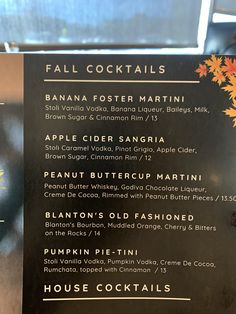 the menu for fall cocktails is displayed in front of a window