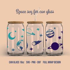 three glass jars with space decals on them, one has a straw in it